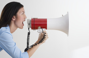 Woman Shouting with Bullhorn --- Image by © Royalty-Free/Corbis